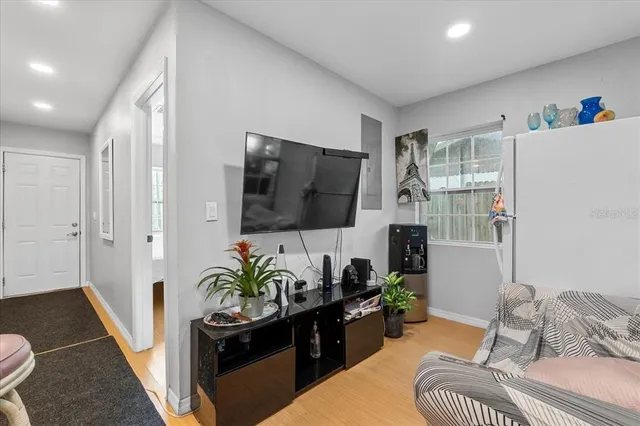 a living room with furniture and a flat screen tv