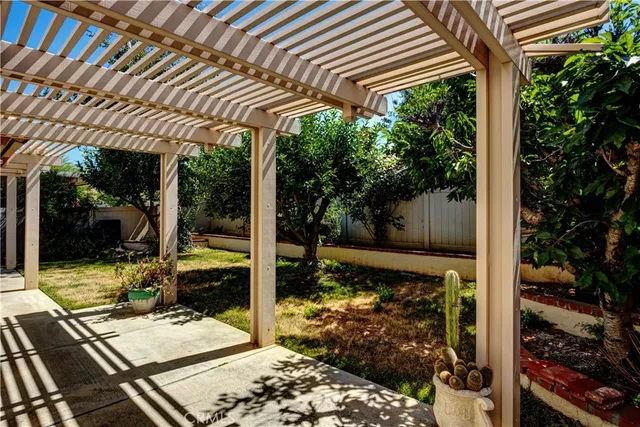 a view of a patio with table and chairs and potted plants
