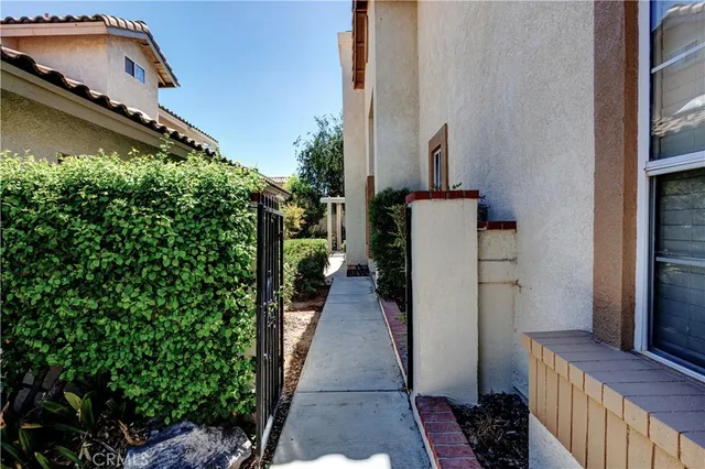a view of a balcony with chairs and wooden floor