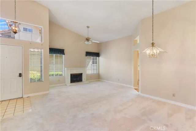 a view of a livingroom with an empty space and a fireplace