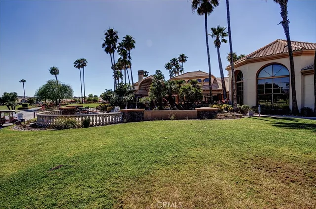 a view of a house with a yard and potted plants