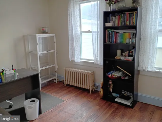 a room with baby crib and a window