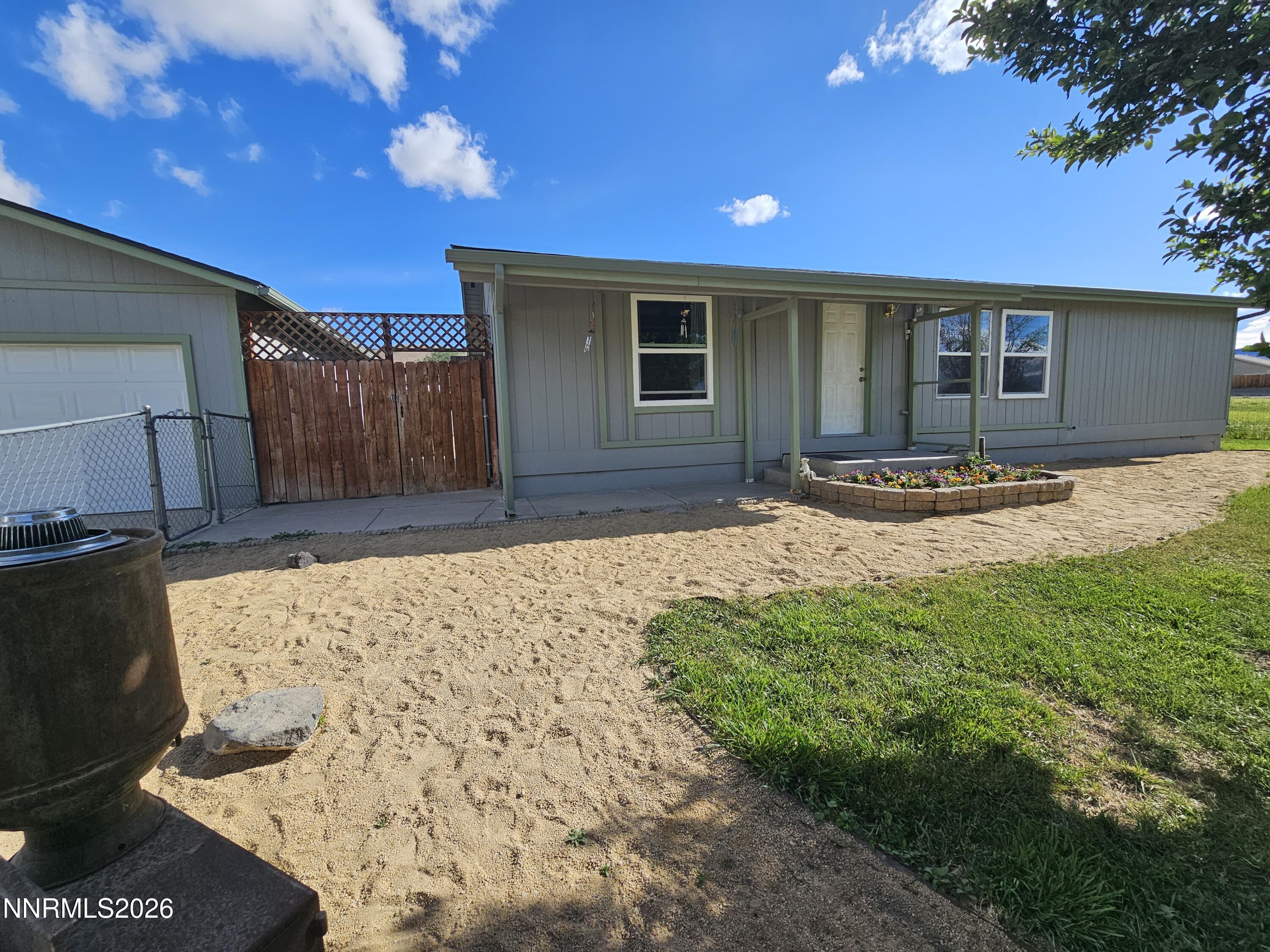 1125 Rancho Road Fernley, NV 89408 - Photo 30 of 47 a front view of a house with a yard