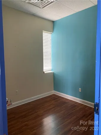 a view of a room with wooden floor and windows
