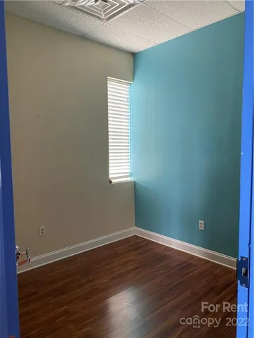 a view of a room with wooden floor and windows