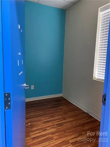 an empty room with wooden floor