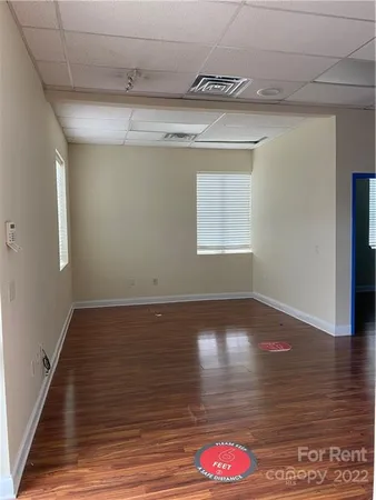 a view of water heater room with wooden floor