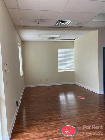 a view of lot of kitchen and hall with wooden floor