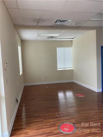 a view of lot of kitchen and hall with wooden floor