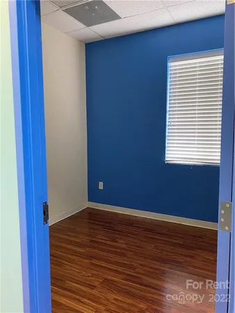 a view of a room with wooden floor and a window