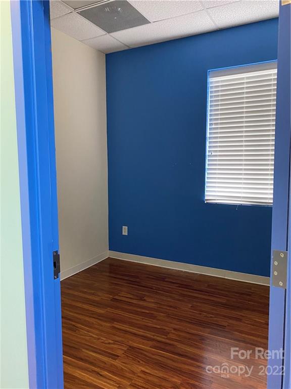 10926 South Tryon Street, Unit D Charlotte, NC 28273 - Photo 9 of 14 a view of a room with wooden floor and a window