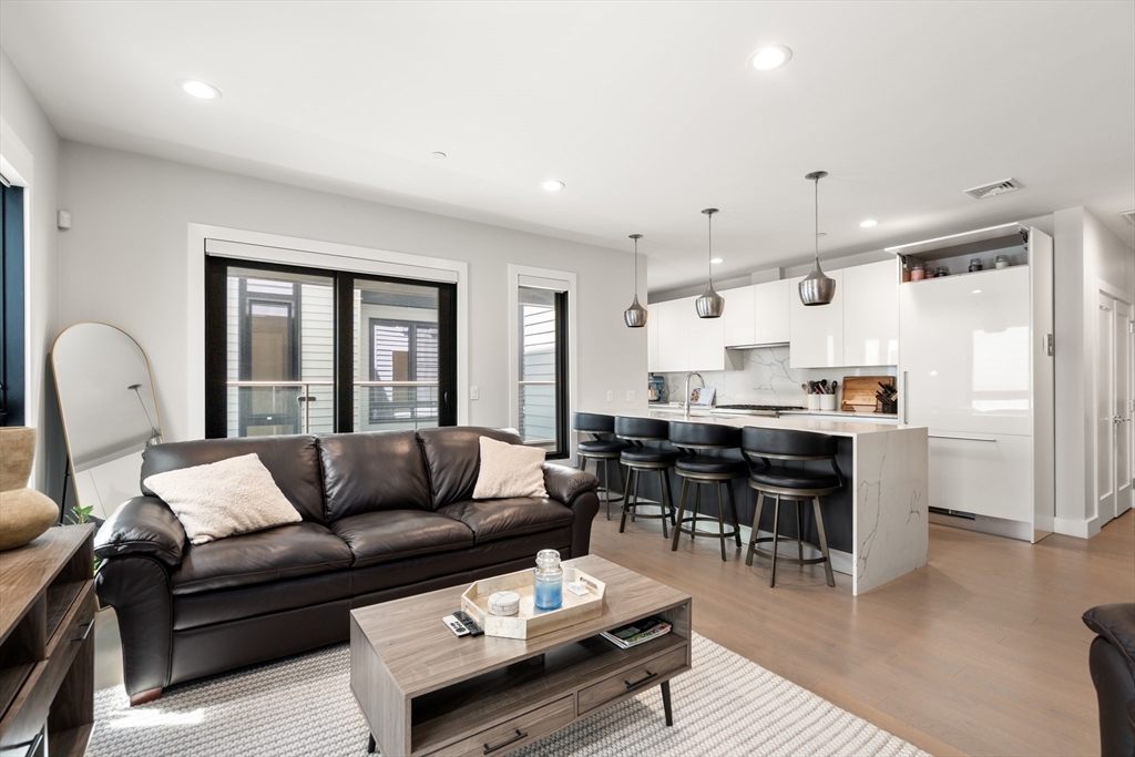39 A Street, Unit 16 Boston, MA 02127 - Photo 2 of 14 a living room with furniture and wooden floor