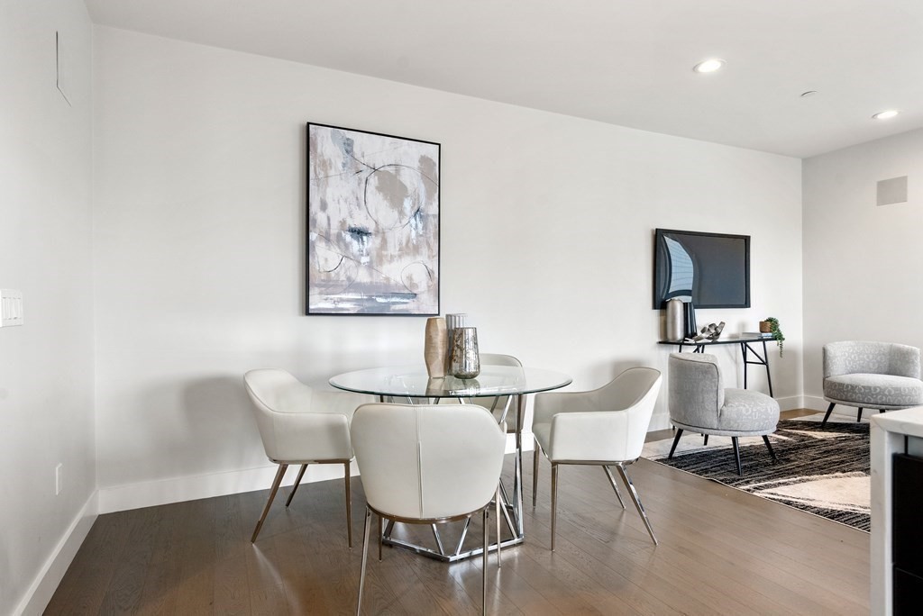 39 A Street, Unit 16 Boston, MA 02127 - Photo 5 of 14 a dining room with furniture and wooden floor