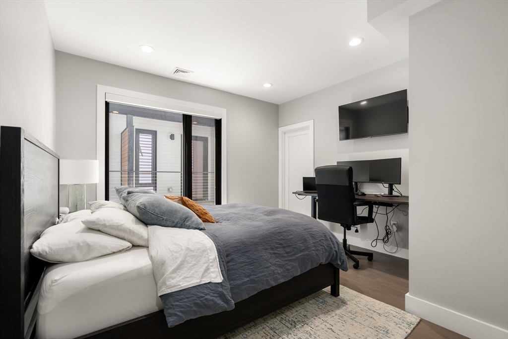 39 A Street, Unit 16 Boston, MA 02127 - Photo 8 of 14 a bedroom with a bed and a flat screen tv
