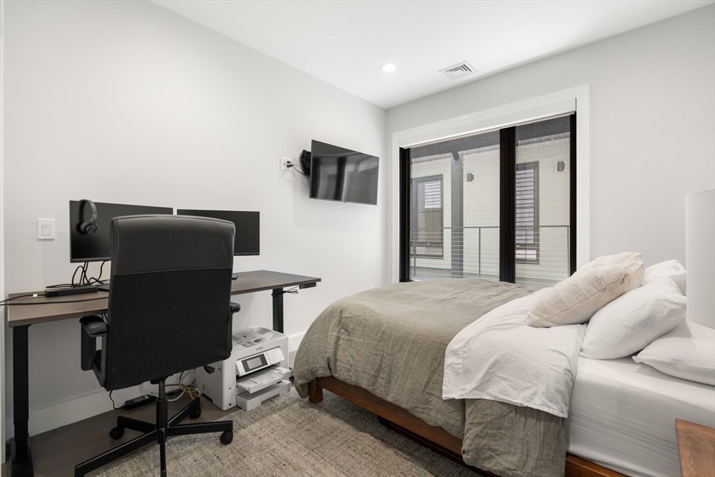 39 A Street, Unit 16 Boston, MA 02127 - Photo 10 of 14 a bedroom with a bed and a desk