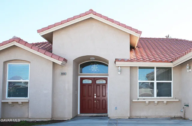 a front view of a house with glass windows