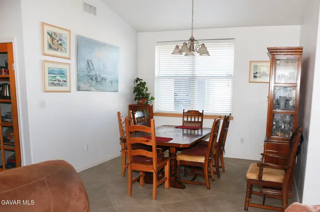 a dining room with furniture and window