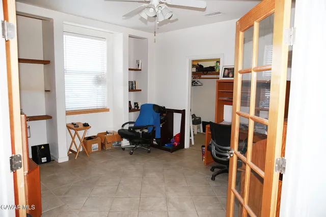 a view of a livingroom with workspace and a window