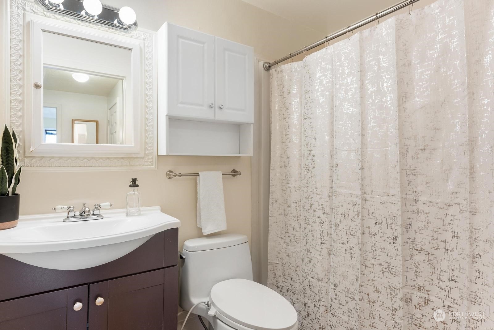 4531 Crescent Avenue Everett, WA 98203 - Photo 13 of 23 a bathroom with a sink a toilet and shower curtain