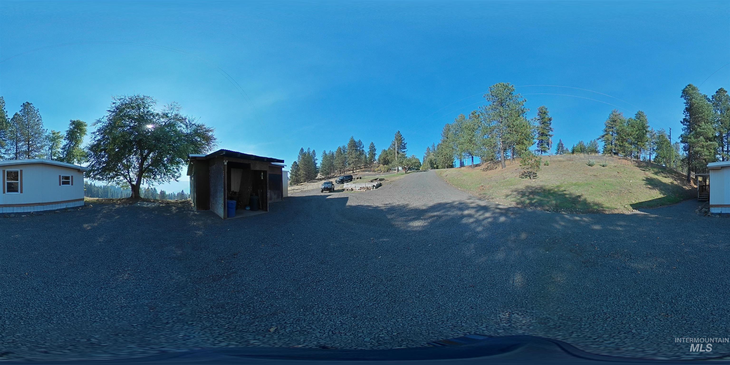 4099 Lakeview Road Orofino, ID 83544 - Photo 23 of 41 Gravel-surfaced lot with multiple structures, including a shed and a mobile home