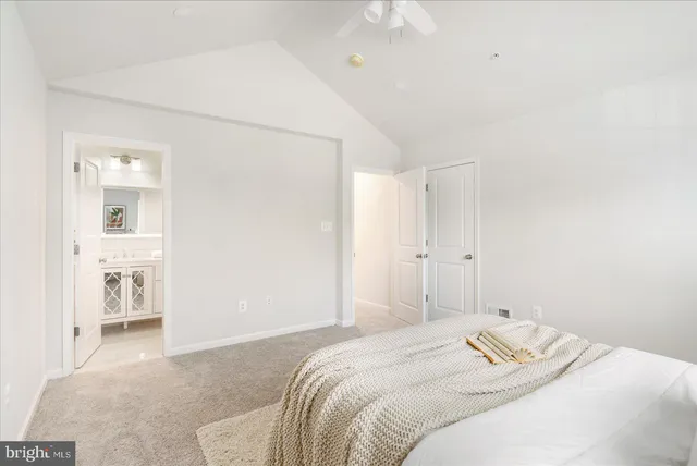 a bedroom with a bed and cabinets