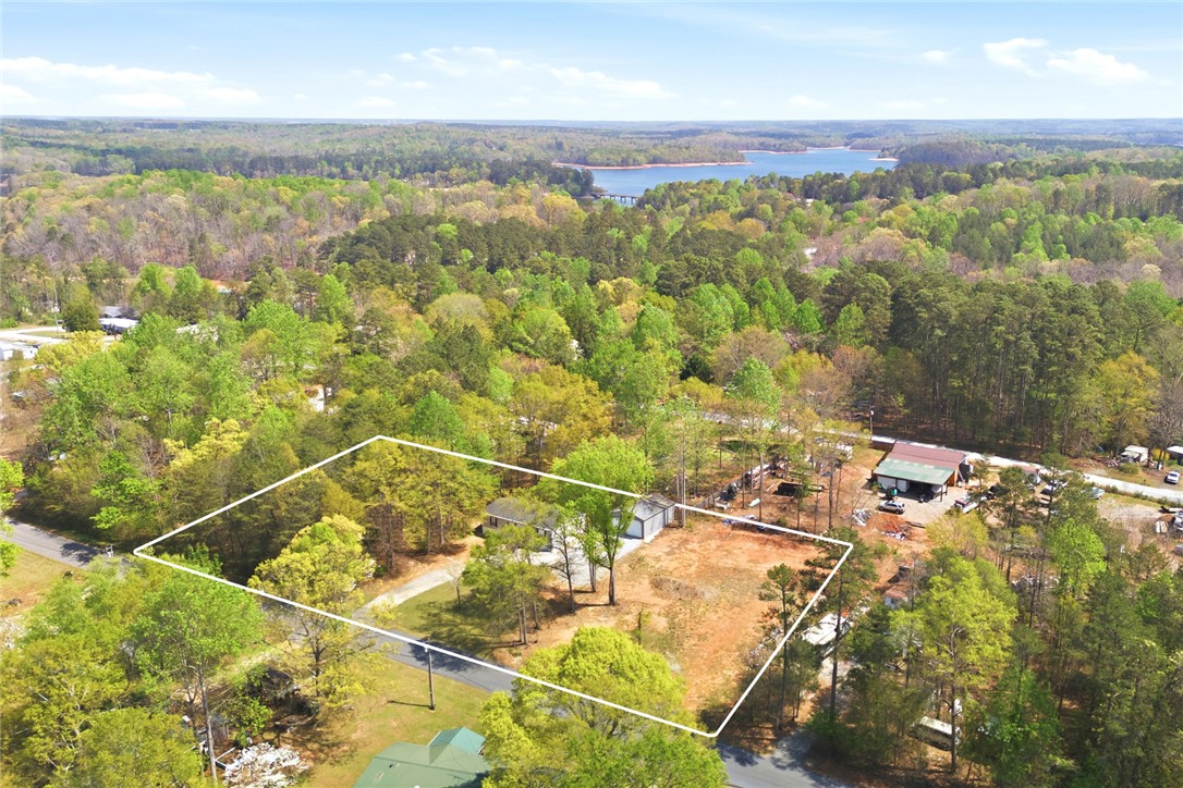 240 Southeast 147 Seneca, SC 29678 - Photo 21 of 27 This expansive property offers a tranquil escape with a lake view, surrounded by lush woodlands.