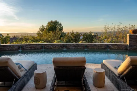 a view of a chairs and table in backyard of the house