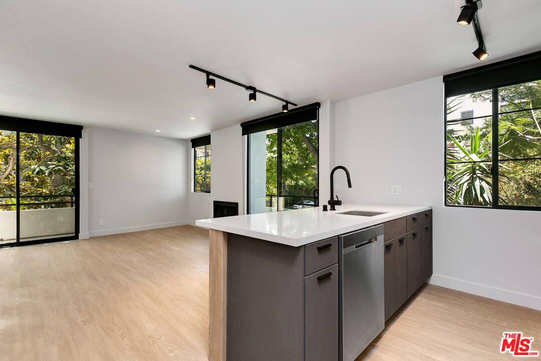a kitchen with a sink and large window