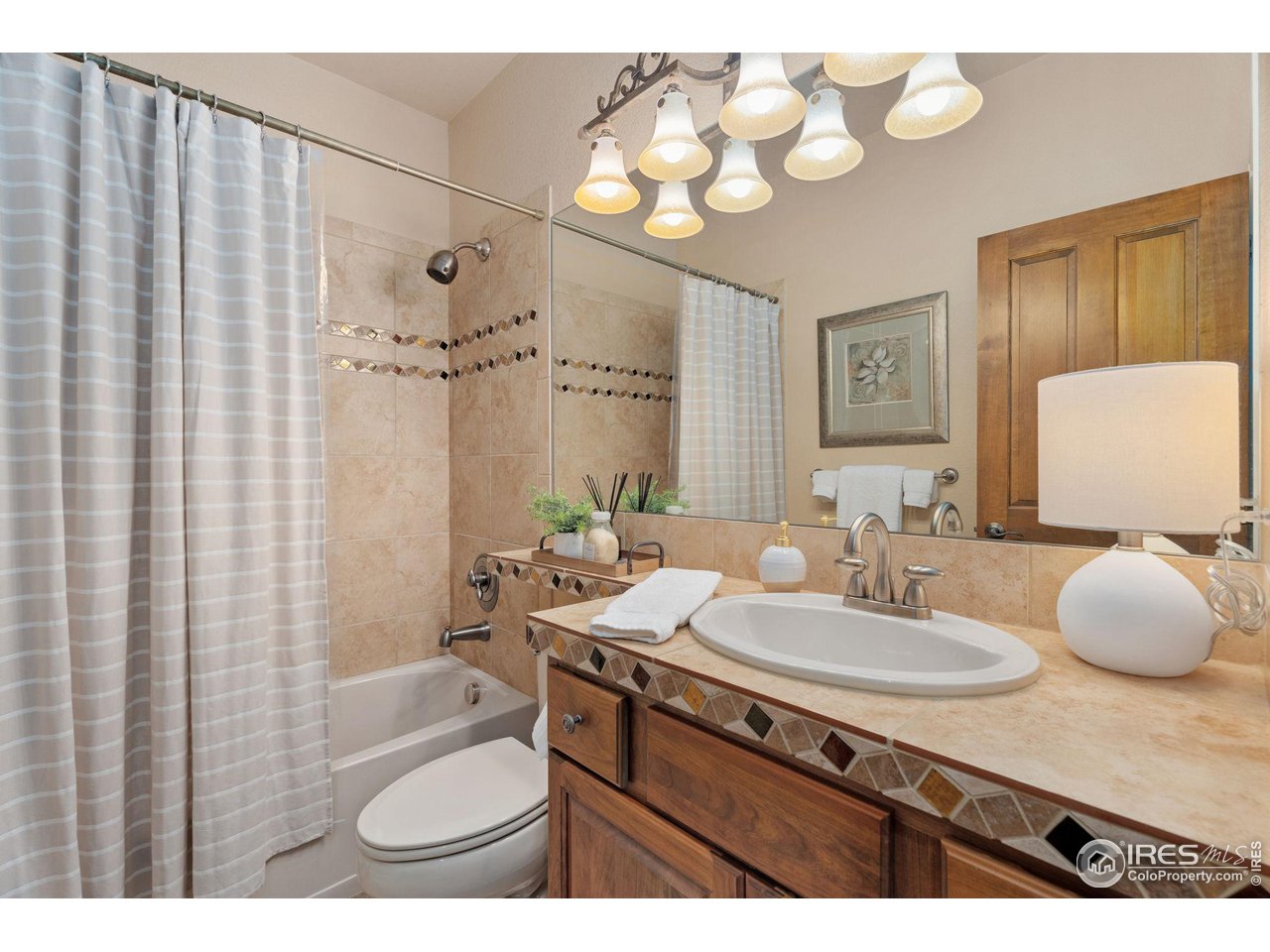 6511 Half Moon Bay Drive Windsor, CO 80550 - Photo 15 of 31 a bathroom with a sink vanity granite and a mirror