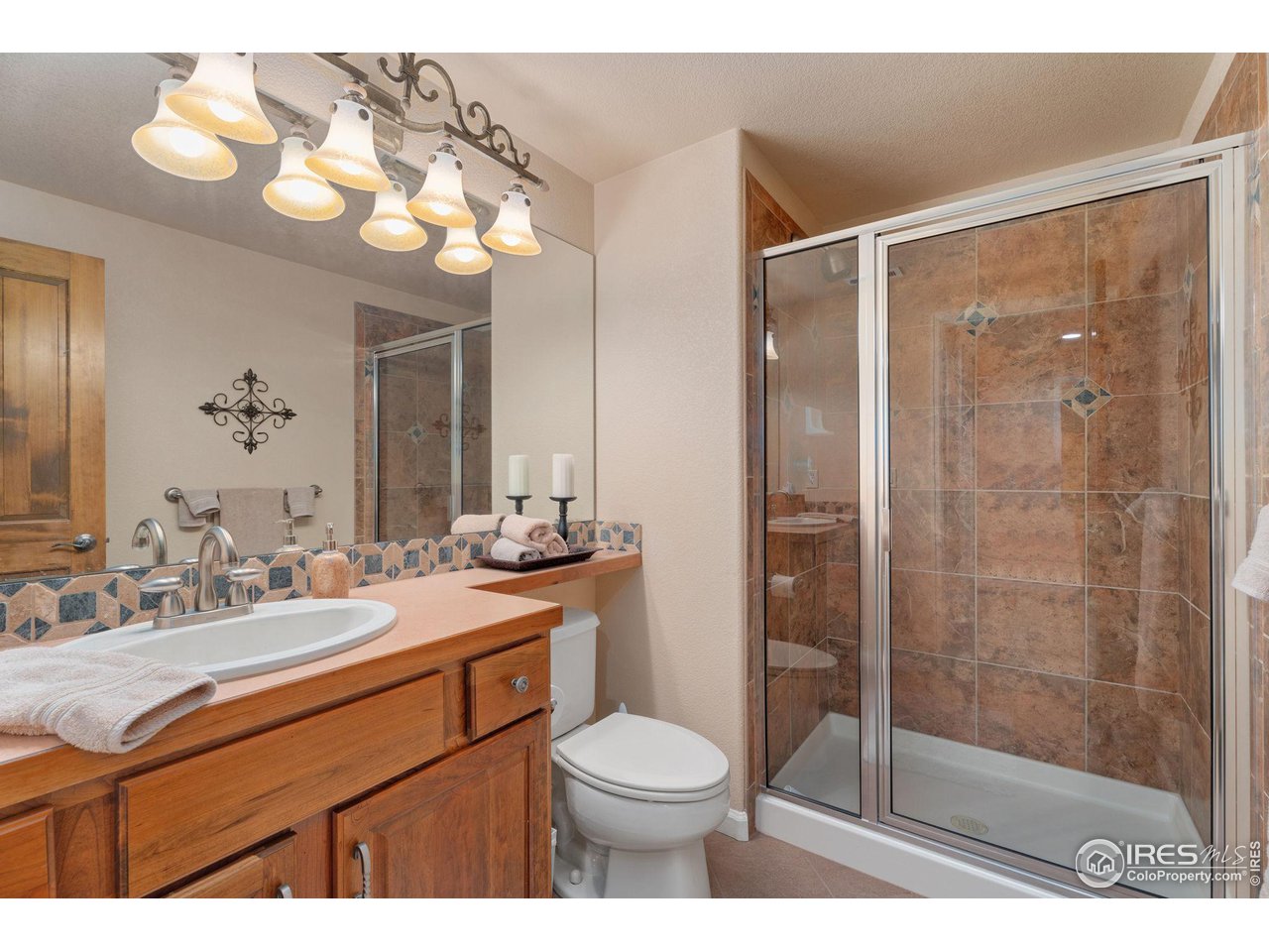 6511 Half Moon Bay Drive Windsor, CO 80550 - Photo 17 of 31 a bathroom with a sink vanity mirror and toilet