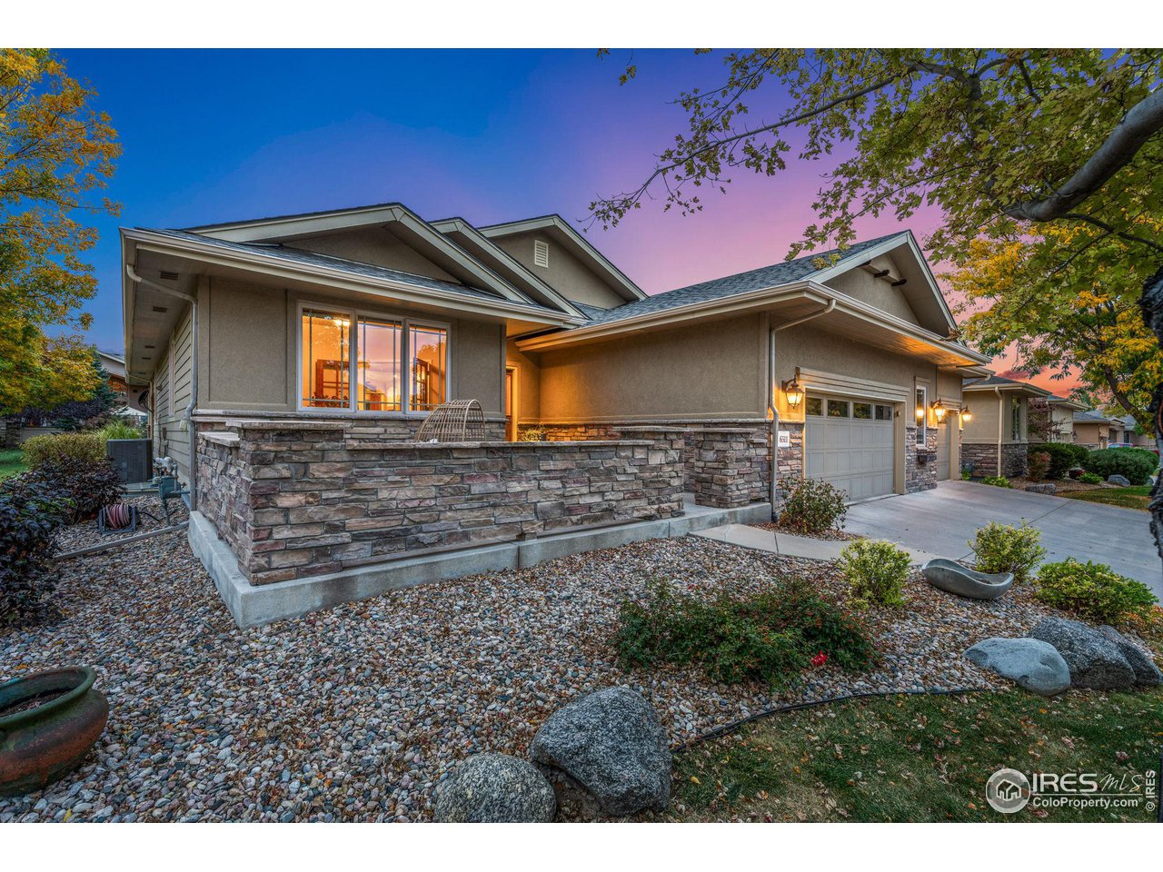 6511 Half Moon Bay Drive Windsor, CO 80550 - Photo 26 of 31 a front view of a house with garden