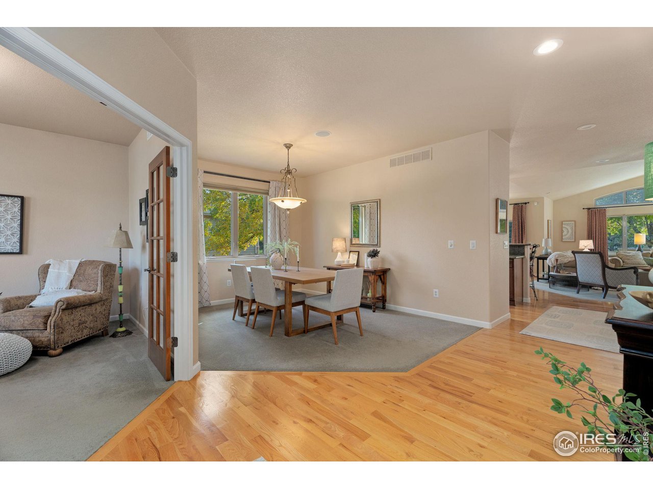 6511 Half Moon Bay Drive Windsor, CO 80550 - Photo 3 of 31 a living room with furniture and a dining table
