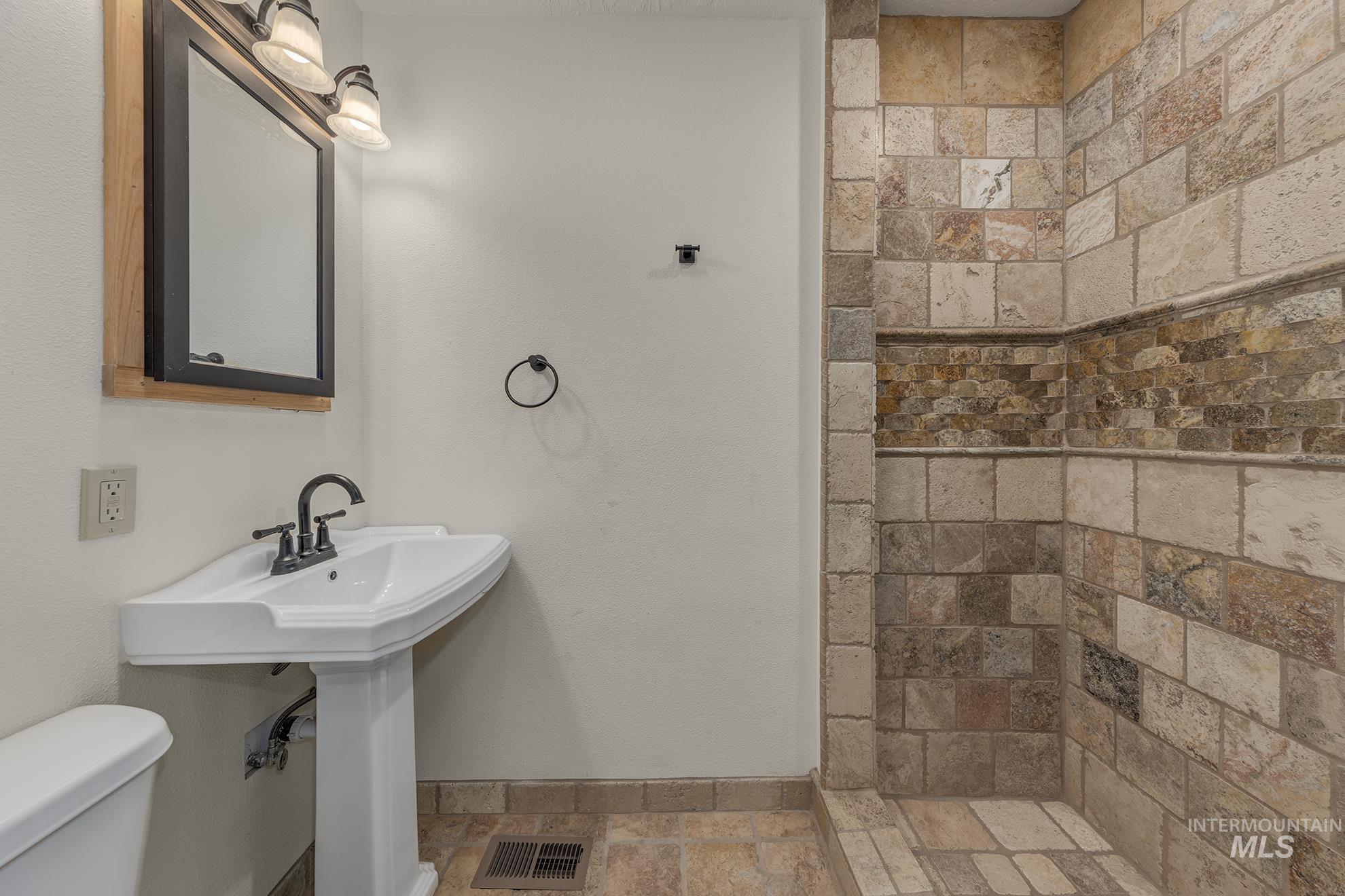327 Macomb Road Weiser, ID 83672 - Photo 21 of 49 Full bath with stone tile floors and a tile shower