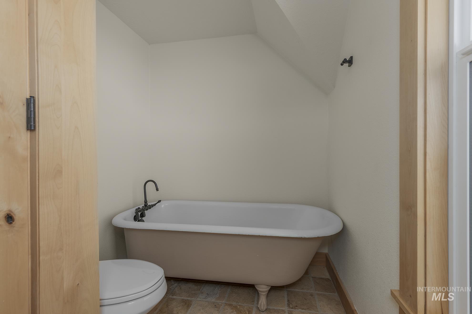 327 Macomb Road Weiser, ID 83672 - Photo 29 of 49 Bathroom with a soaking tub and toilet