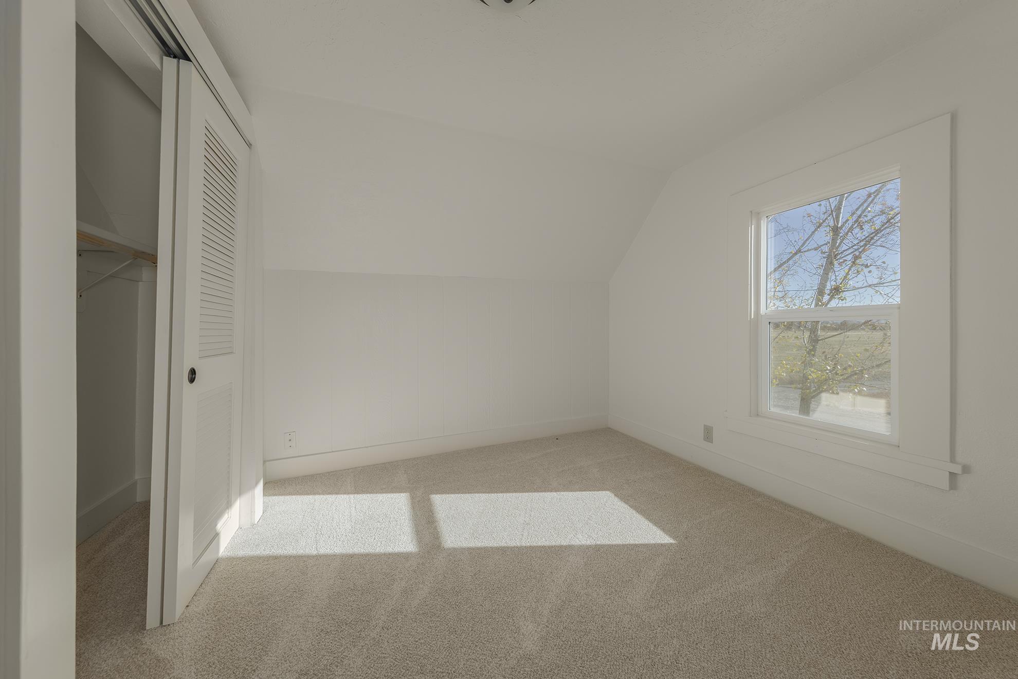 327 Macomb Road Weiser, ID 83672 - Photo 32 of 49 Additional living space featuring lofted ceiling and carpet floors