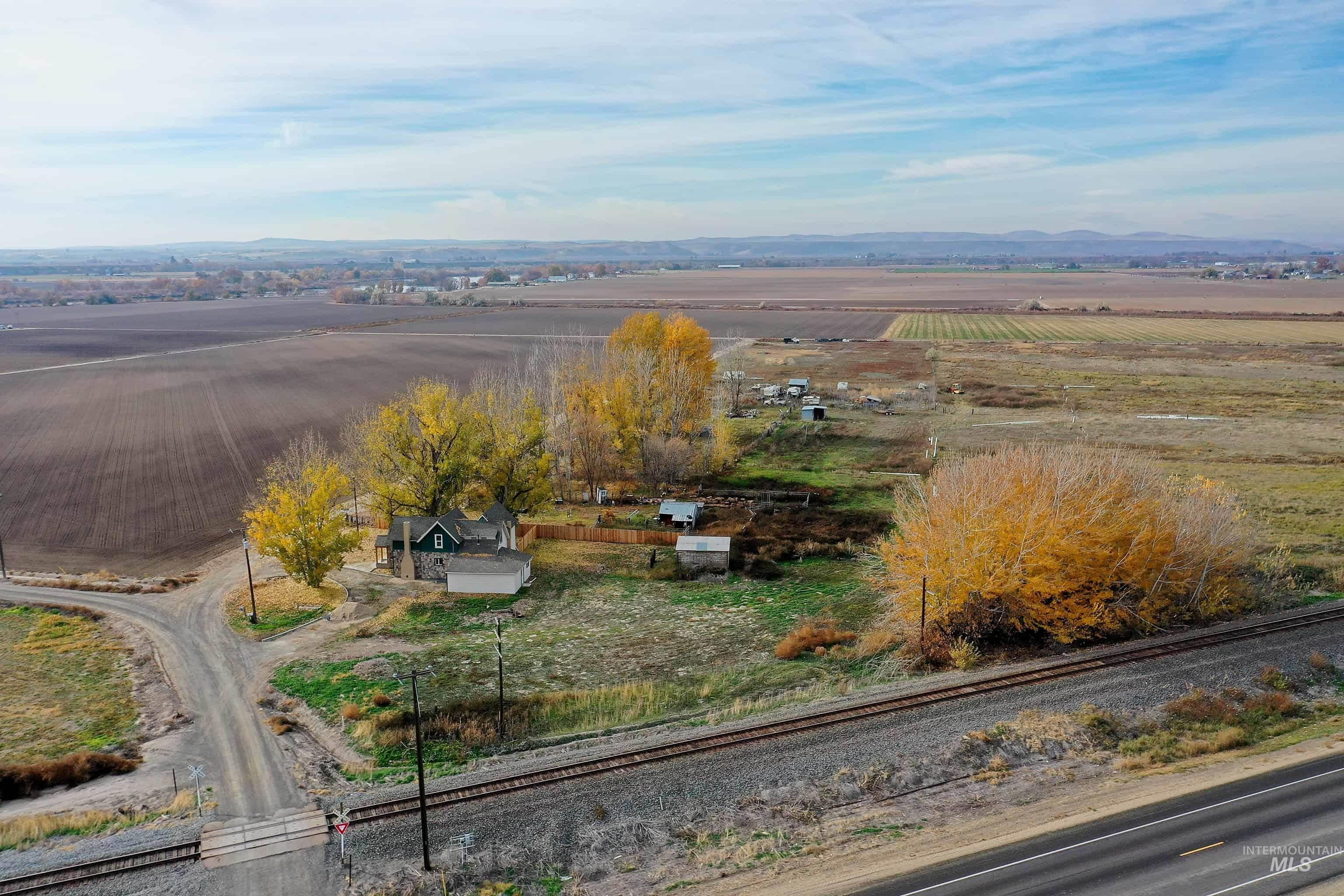 327 Macomb Road Weiser, ID 83672 - Photo 48 of 49 Aerial view of sparsely populated area featuring a mountain backdrop and large plots for crops