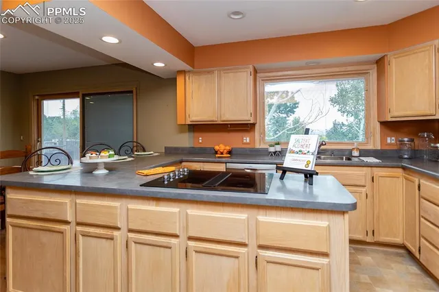 a kitchen with sink refrigerator and window