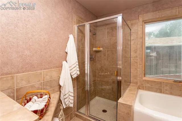 a bathroom with a bathtub and a shower