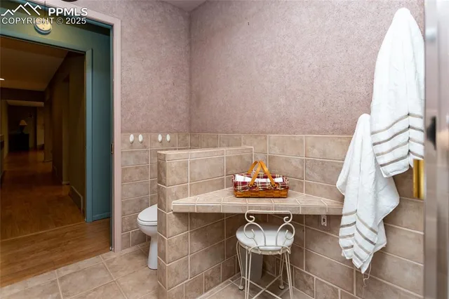 a living room with furniture a flat screen tv and a floor to ceiling window