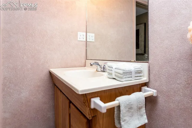 a view of a balcony with two chairs and a potted plant