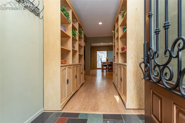 a view of hallway with wooden floor and stairs