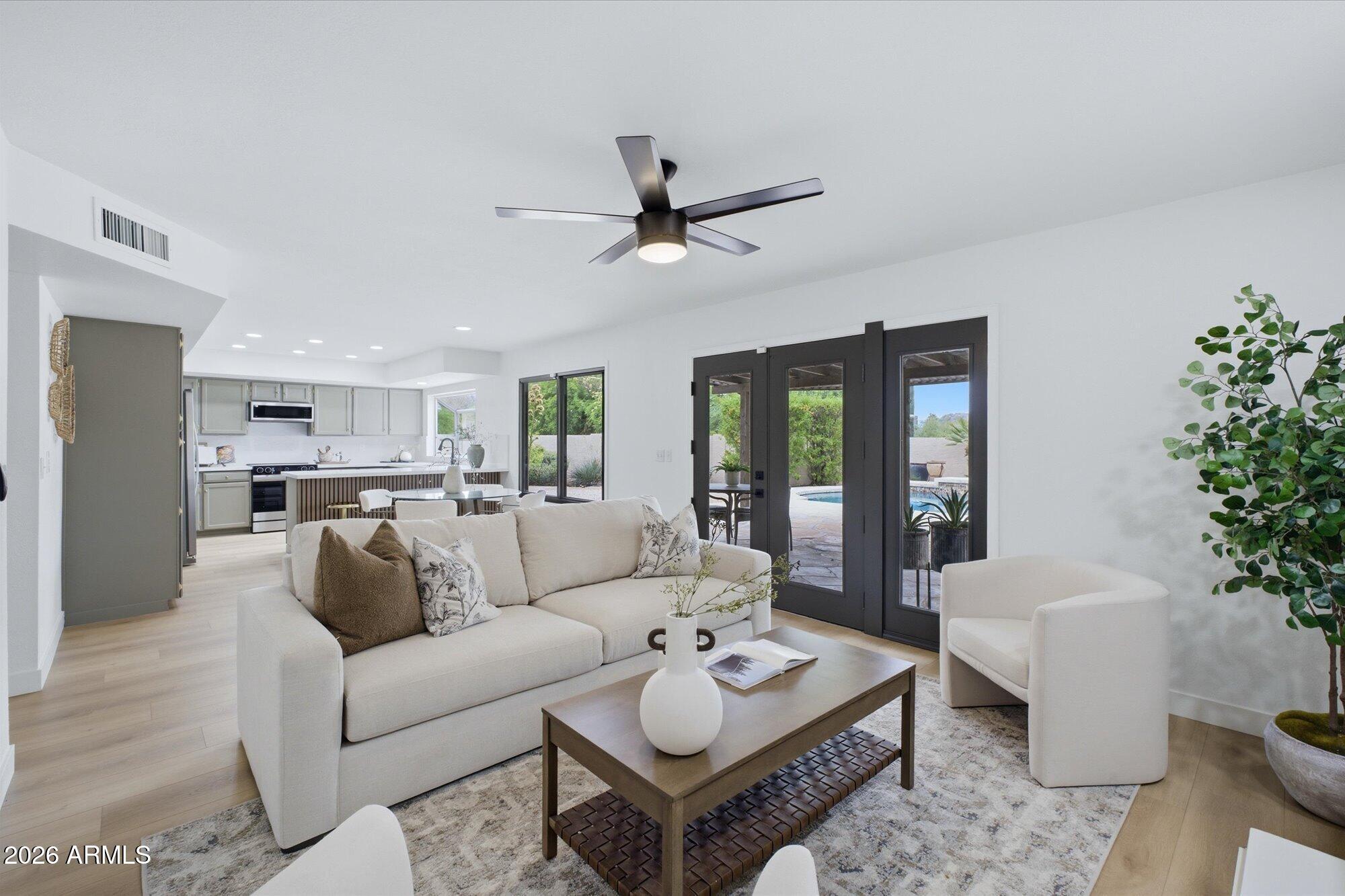 405 East Marny Road Tempe, AZ 85288 - Photo 11 of 36 a living room with furniture potted plant and a large window