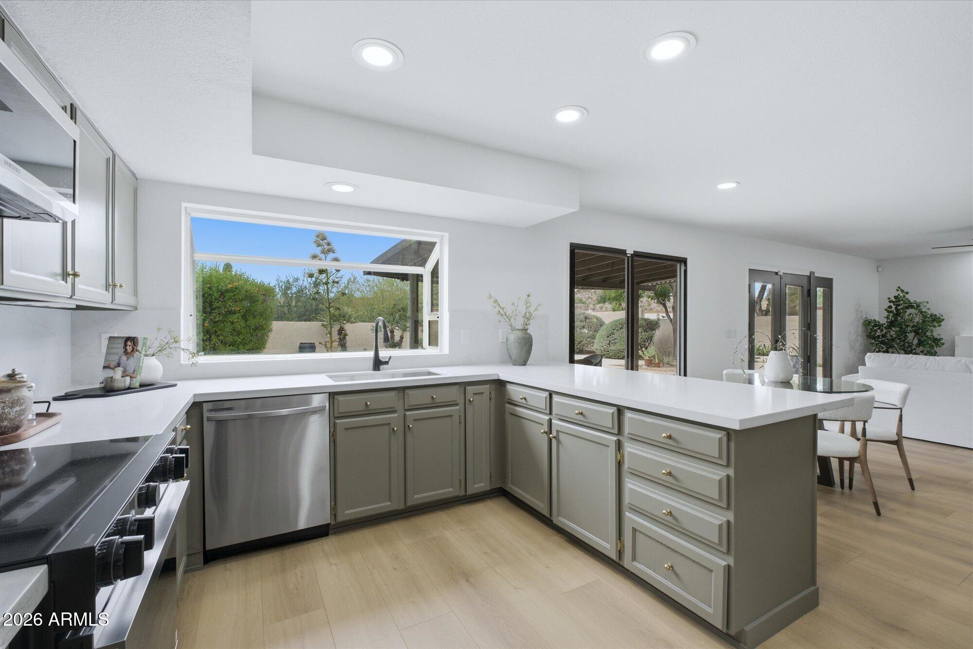 405 East Marny Road Tempe, AZ 85288 - Photo 14 of 36 a large kitchen with stainless steel appliances lots of counter space sink and cabinets