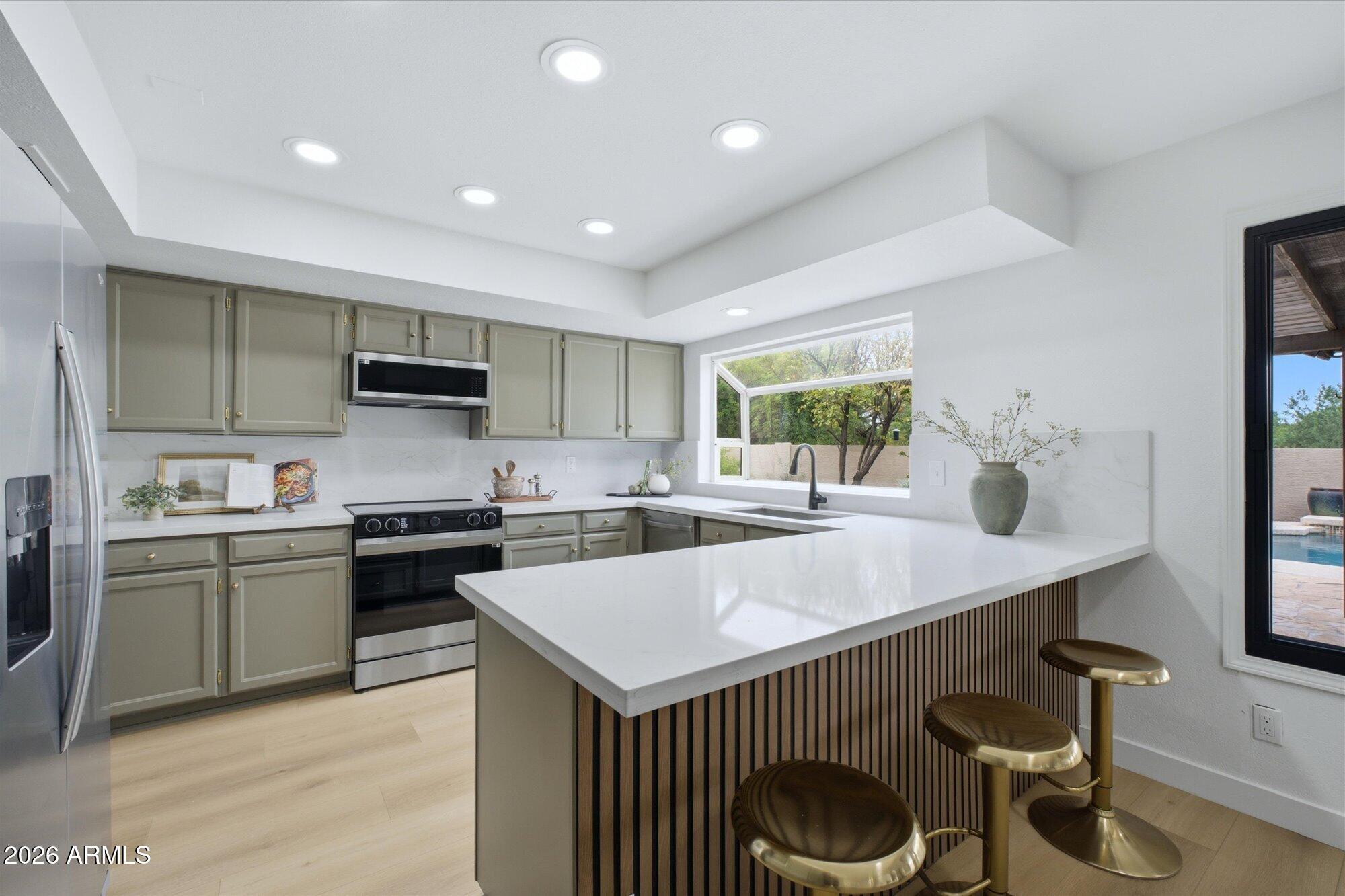 405 East Marny Road Tempe, AZ 85288 - Photo 15 of 36 a kitchen that has a lot of cabinets a sink and a stove in it