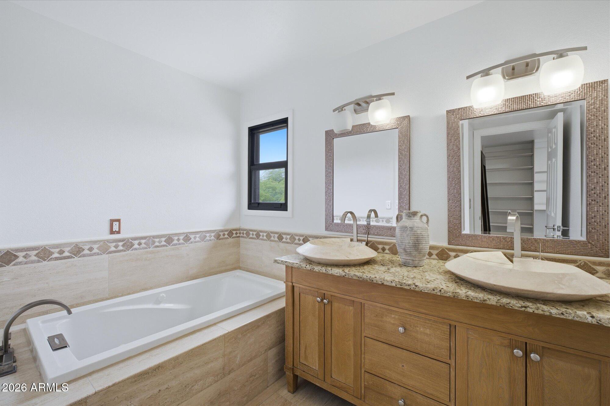 405 East Marny Road Tempe, AZ 85288 - Photo 20 of 36 a bathroom with a granite countertop tub sink and mirror