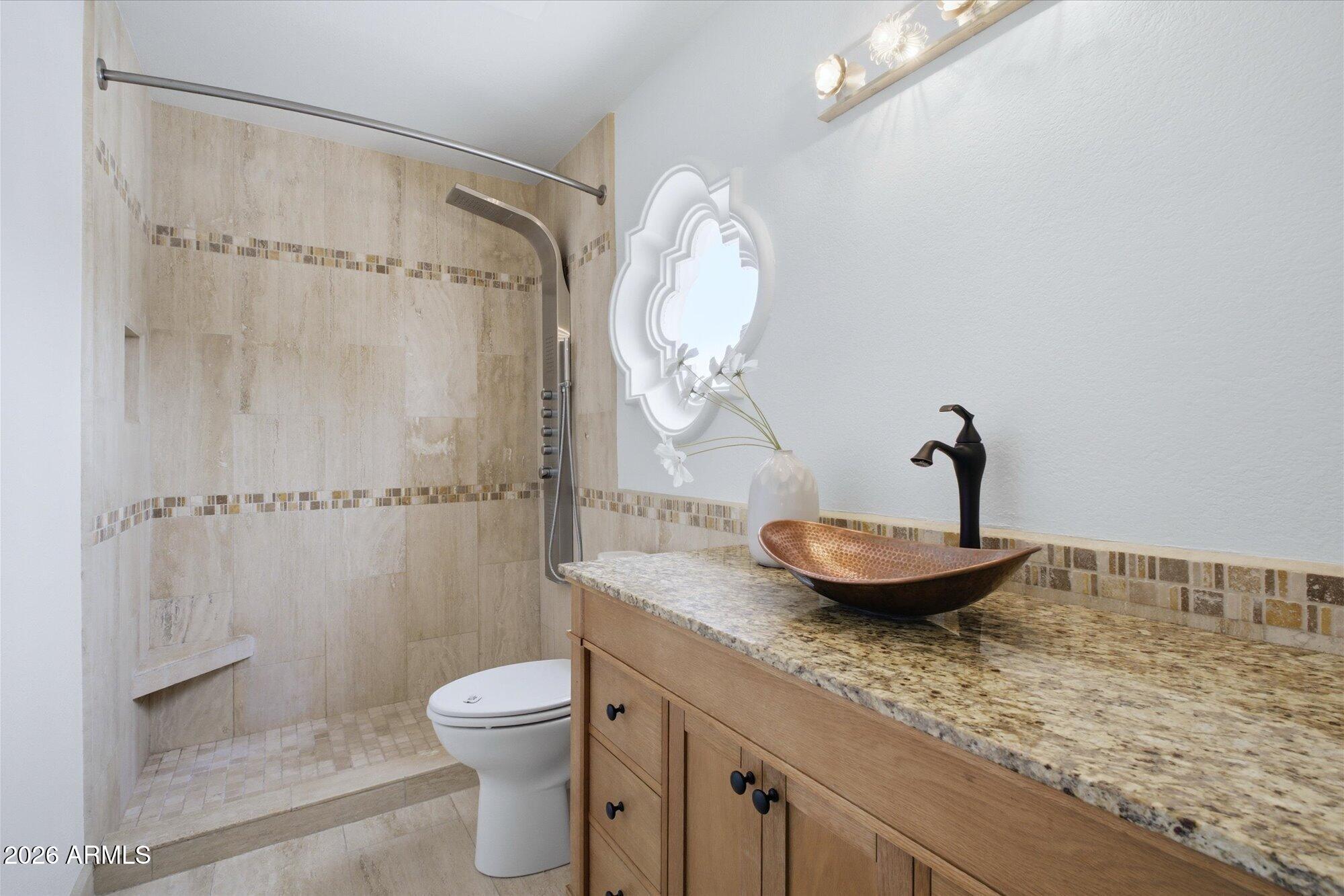 405 East Marny Road Tempe, AZ 85288 - Photo 23 of 36 a bathroom with a granite countertop sink a toilet and a shower