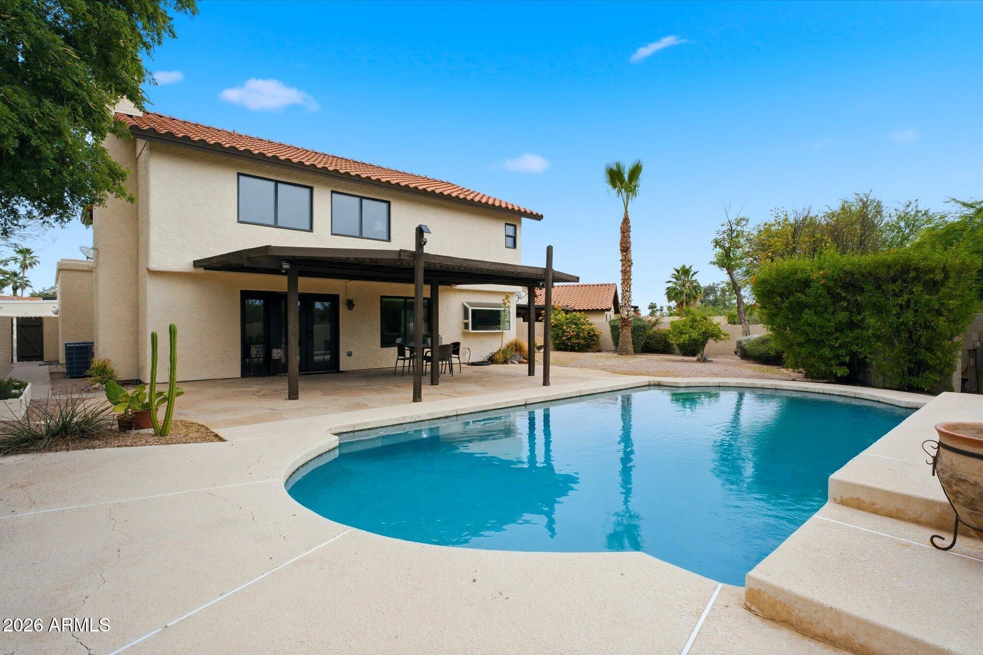 405 East Marny Road Tempe, AZ 85288 - Photo 30 of 36 a view of a swimming pool with outdoor seating