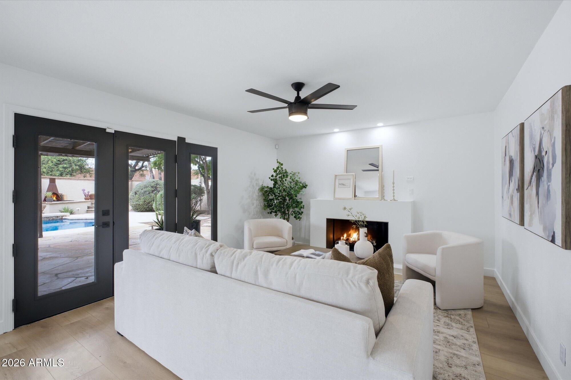 405 East Marny Road Tempe, AZ 85288 - Photo 10 of 36 a living room with furniture a fireplace and a chandelier