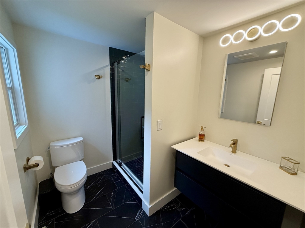 1 Maureen Road Lexington, MA 02420 - Photo 13 of 20 a bathroom with a toilet sink and mirror