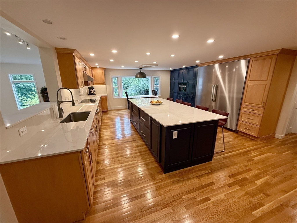 1 Maureen Road Lexington, MA 02420 - Photo 3 of 20 a large dining hall with stainless steel appliances a sink dishwasher a stove with wooden floor